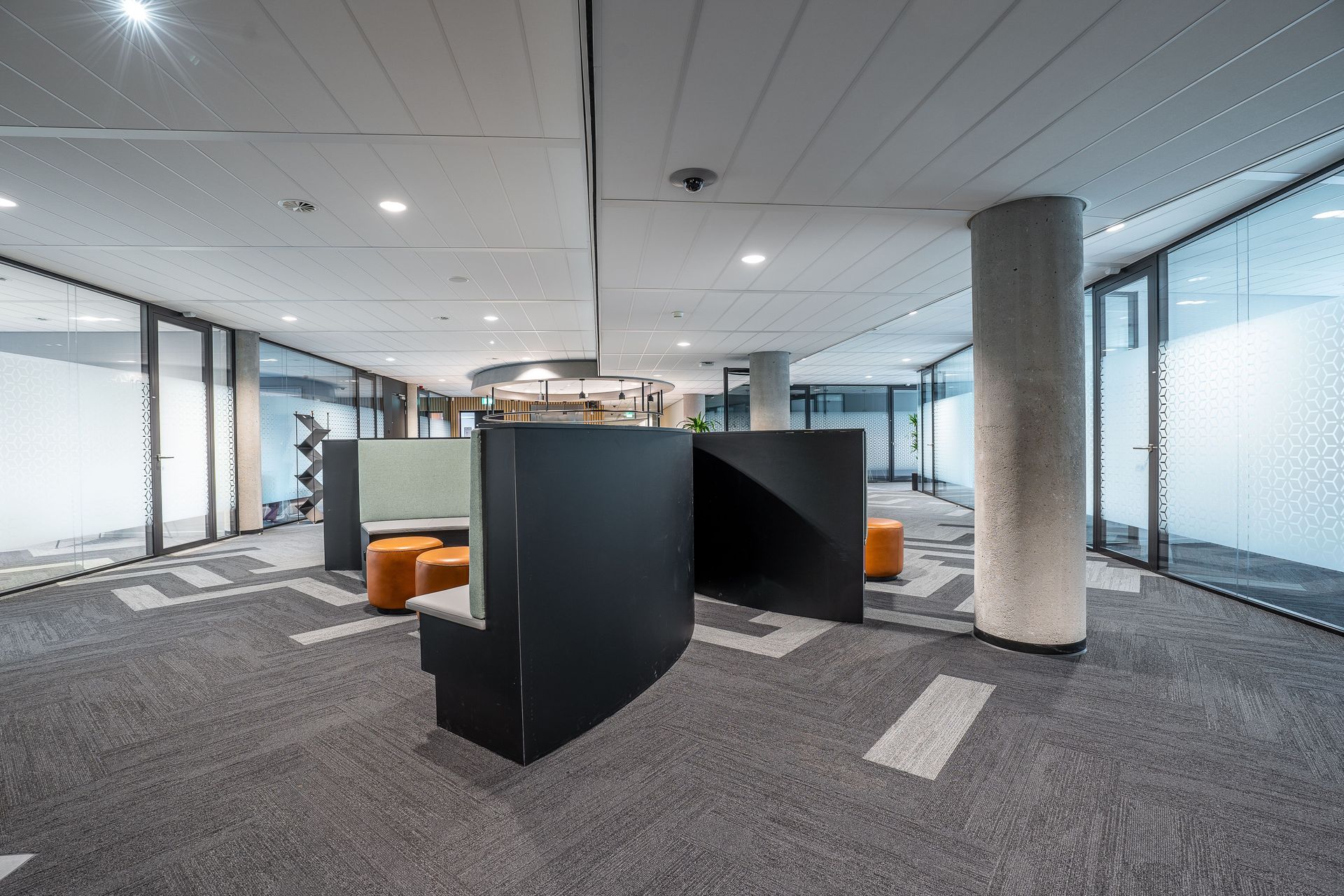 Spacious modern office interior featuring contemporary furniture and open workspace.